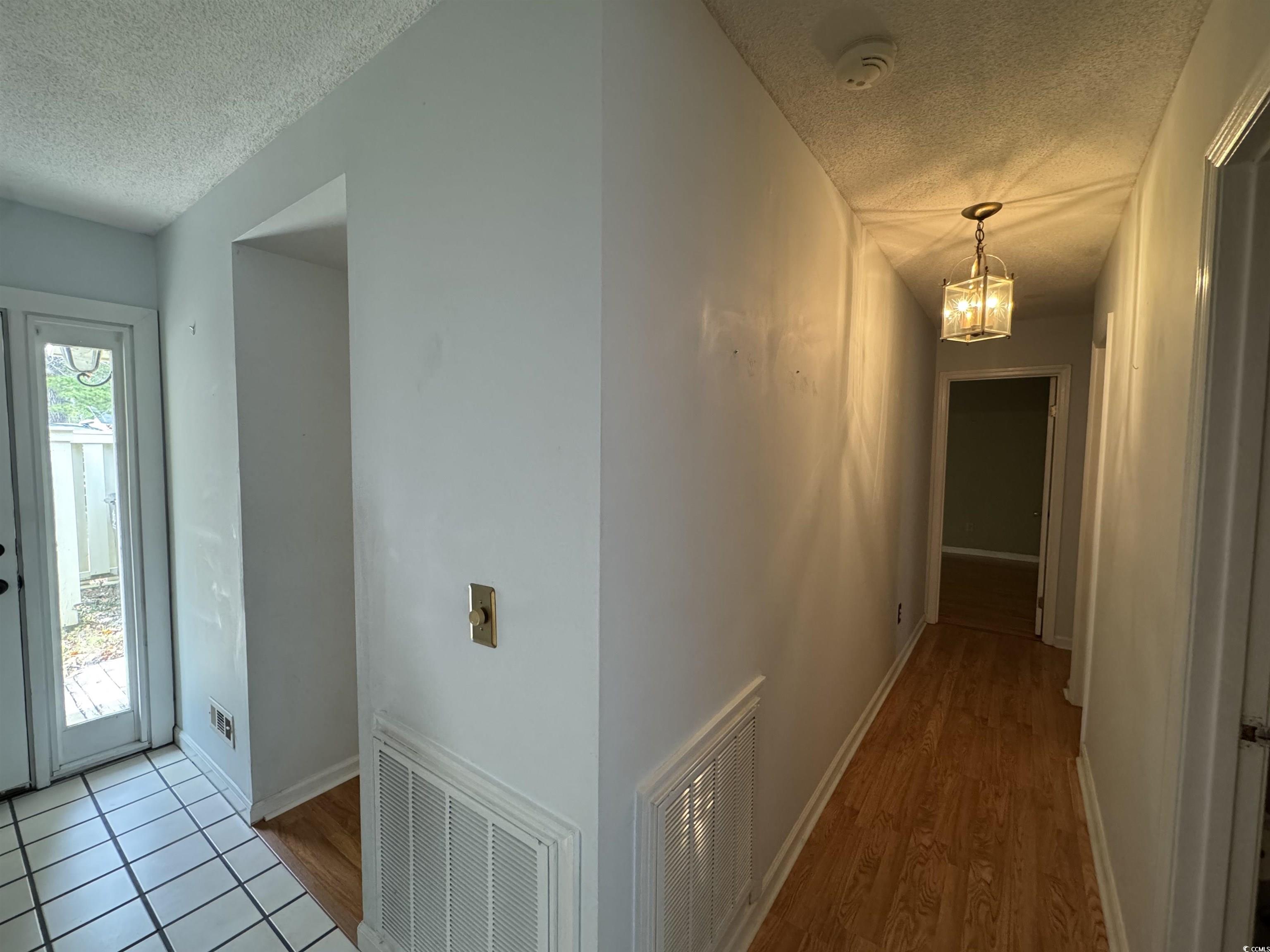 58 Wedgefield Village Road, Unit 48 Georgetown, SC 29440 - Photo 7 of 23 Corridor with a textured ceiling and light wood finished floors