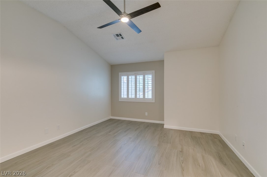 540 Sutters Mill Road Henderson, NV 89014 - Photo 34 of 46 This airy room features a vaulted ceiling, durable laminate flooring, and adjustable plantation shutters.