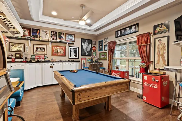 a living room with furniture a ceiling fan and a rug
