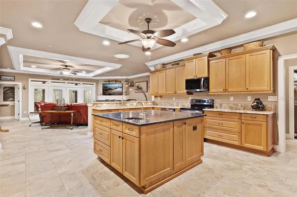 a bedroom with a bed couches and a flat tv screen
