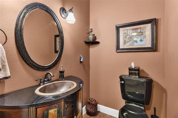 an aerial view of a house with a yard and lake view