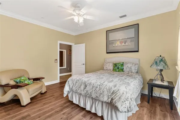 an aerial view of a house with swimming pool and large trees