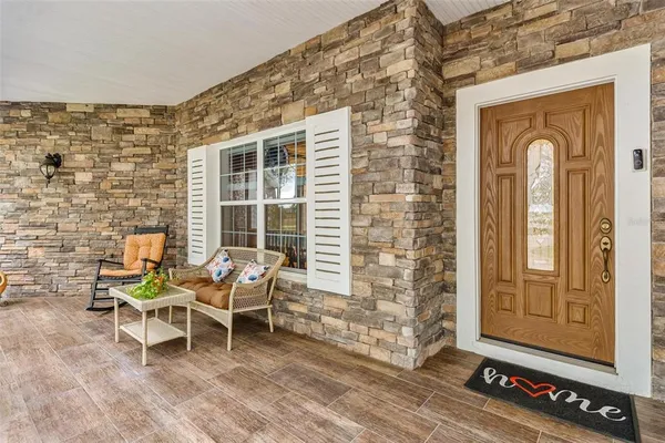a living room with furniture a fireplace and a chandelier