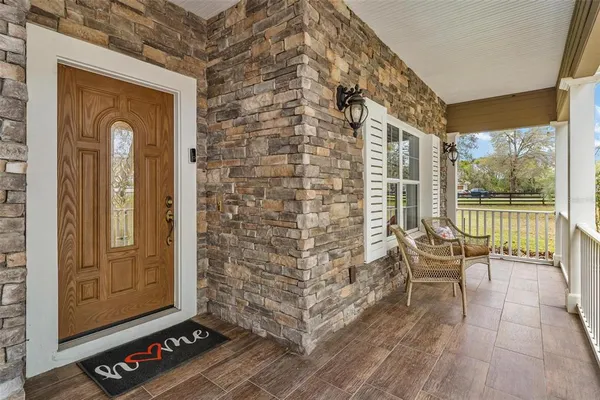 a living room with furniture a chandelier and a flat screen tv