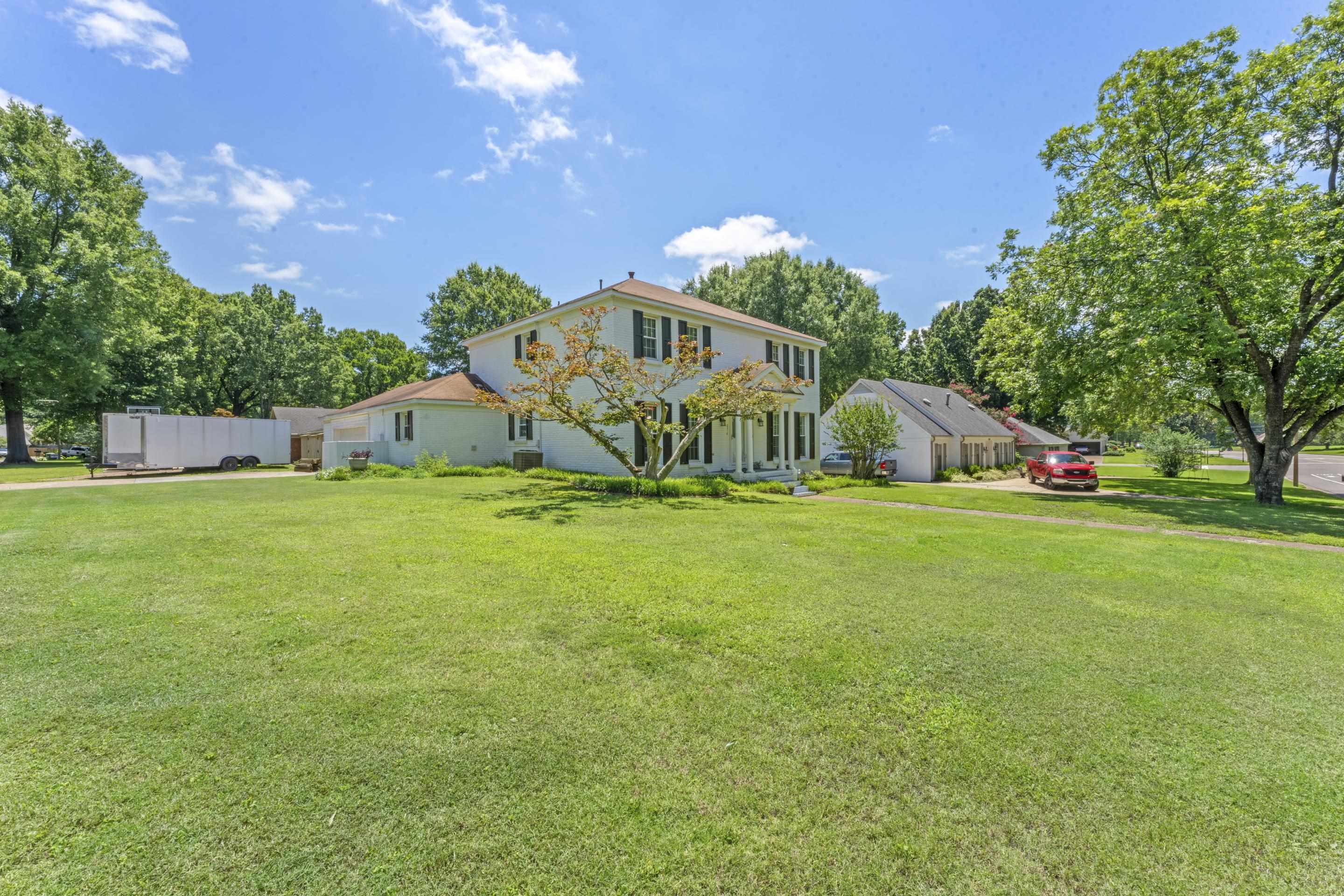 2218 Riverdale Road Germantown, TN 38138 - Photo 37 of 40 Beautiful curb appeal with mature trees, expansive lawn space, and timeless architectural design.
