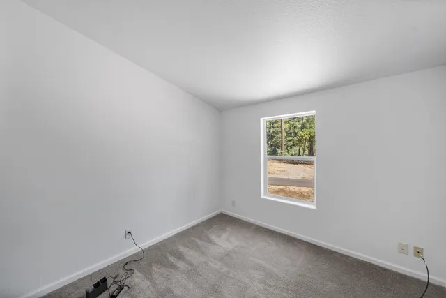 a couple of table and chairs under an umbrella