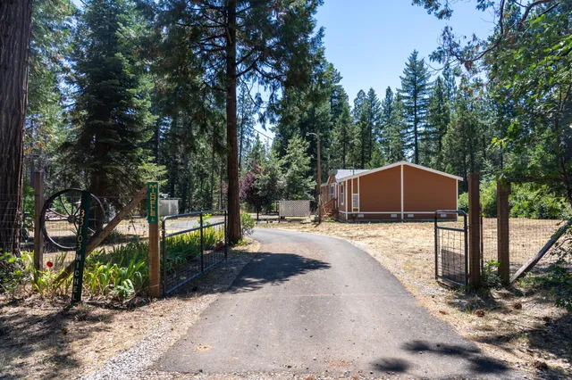 a front view of a house with a yard covered in snow
