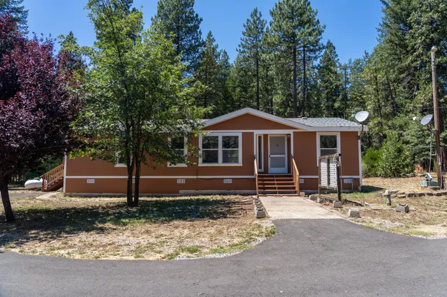 a backyard of a house with yard and outdoor seating
