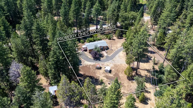 an aerial view of a house with a yard