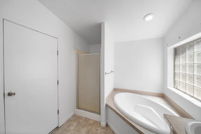 a bathroom with a tub and shower