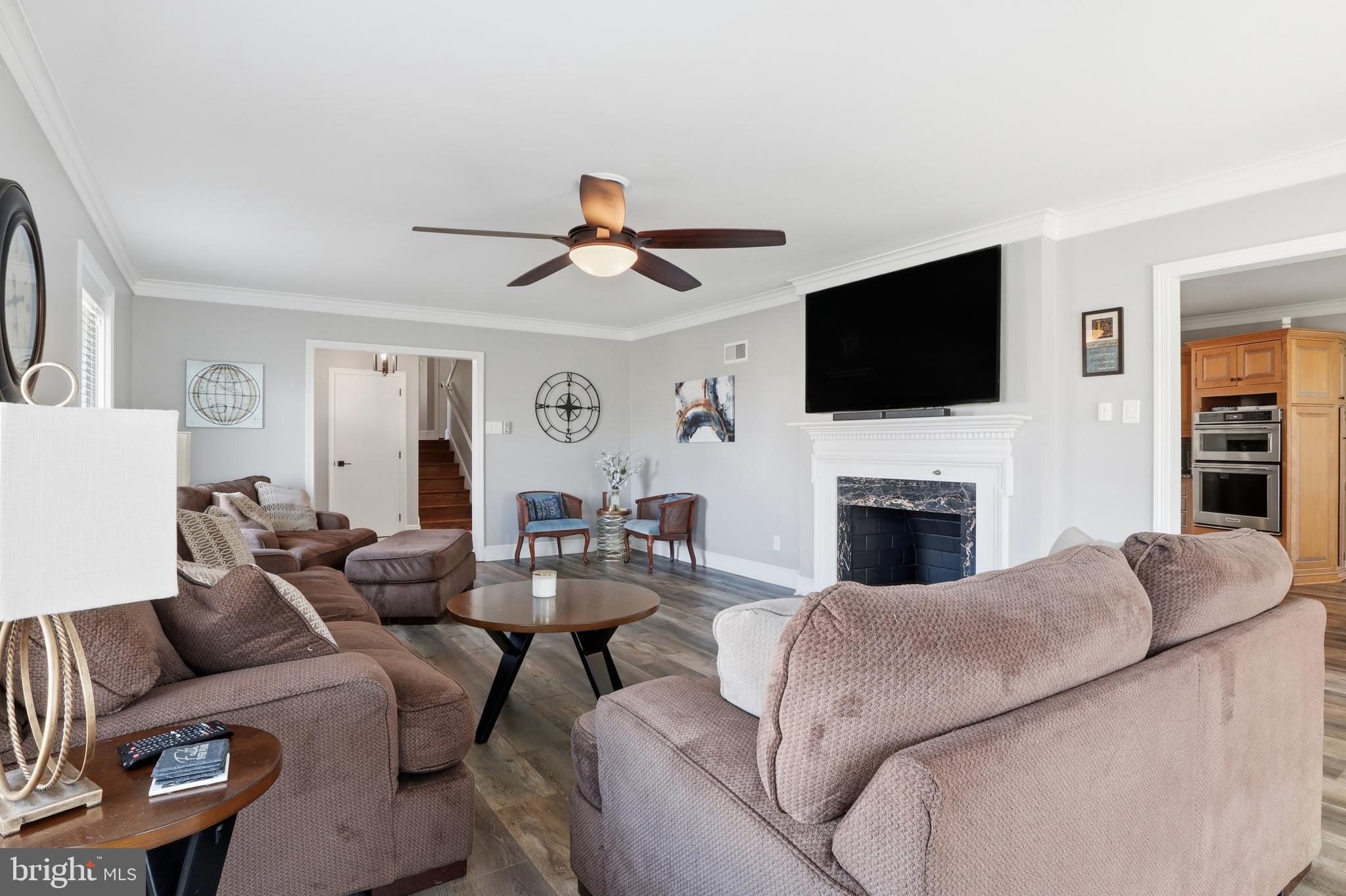 1000 Smallbrook Lane York, PA 17403 - Photo 12 of 84 a living room with furniture a fireplace and a flat screen tv