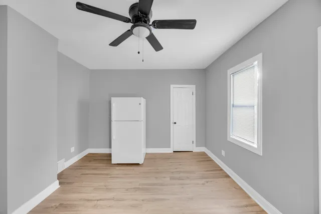 a view of a kitchen with a sink and wooden floor