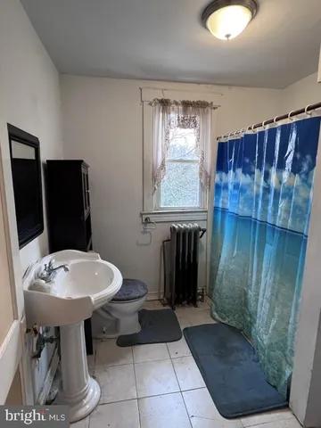 a bathroom with a sink toilet and mirror