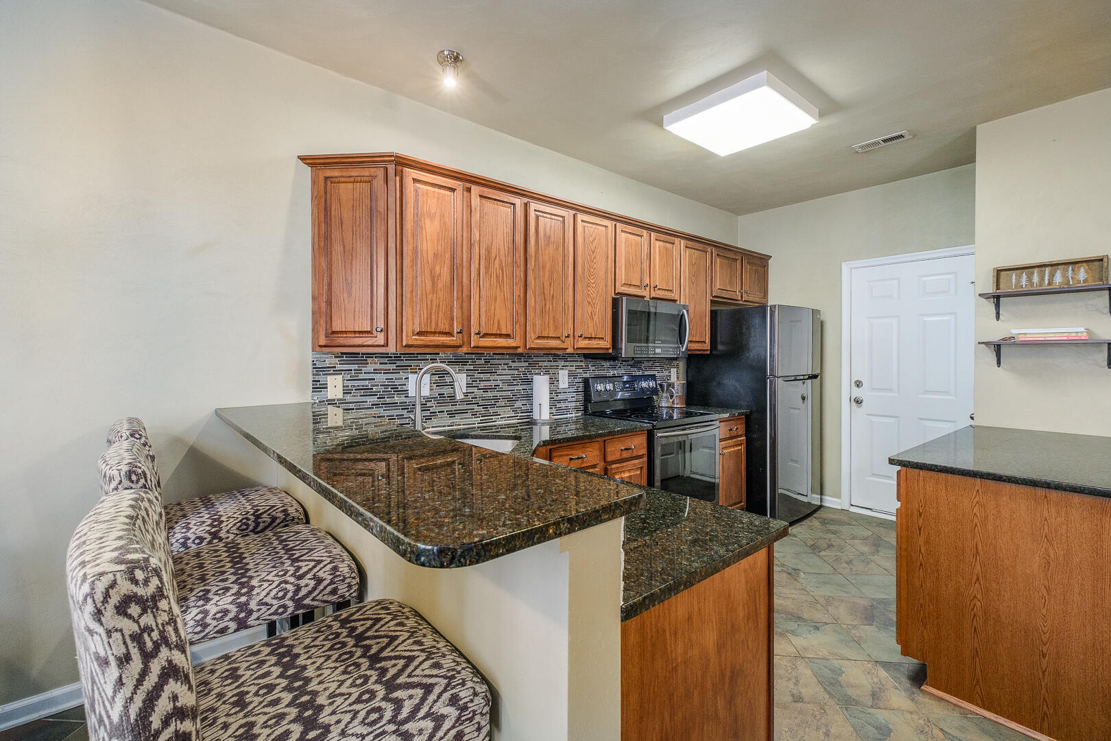 8717 Little Hoop Road Roanoke, VA 24019 - Photo 11 of 31 a kitchen with stainless steel appliances granite countertop a sink stove and refrigerator