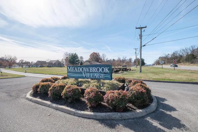 a picture of a bench in front of a wall