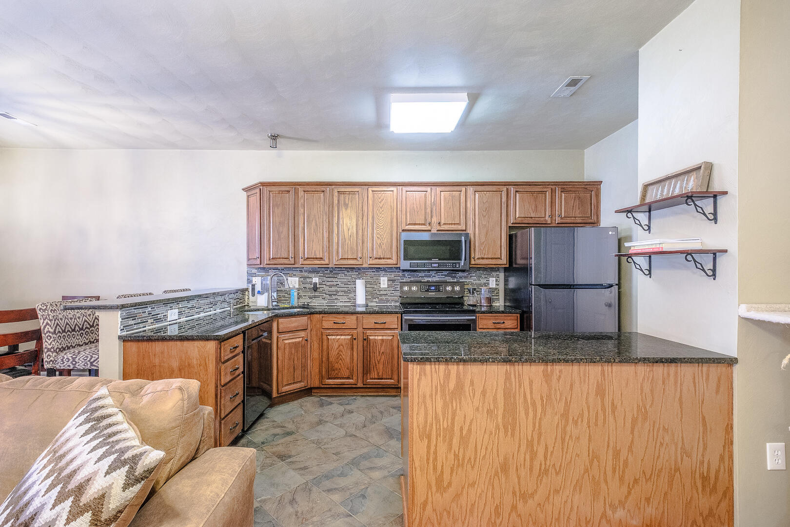 8717 Little Hoop Road Roanoke, VA 24019 - Photo 5 of 31 a kitchen with stainless steel appliances granite countertop a refrigerator a stove top oven a sink and dishwasher