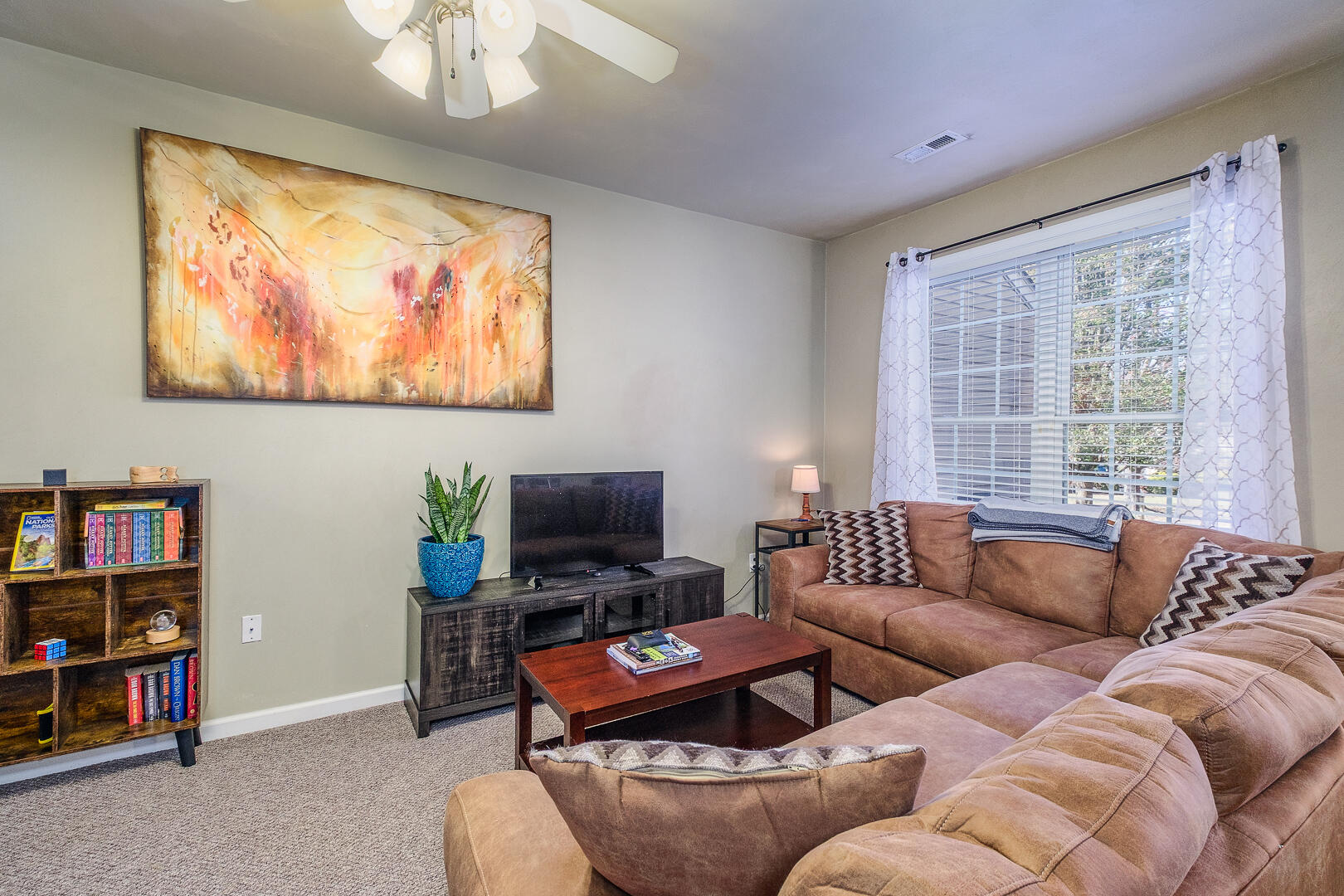 8717 Little Hoop Road Roanoke, VA 24019 - Photo 7 of 31 a living room with furniture a flat screen tv and a bookshelf