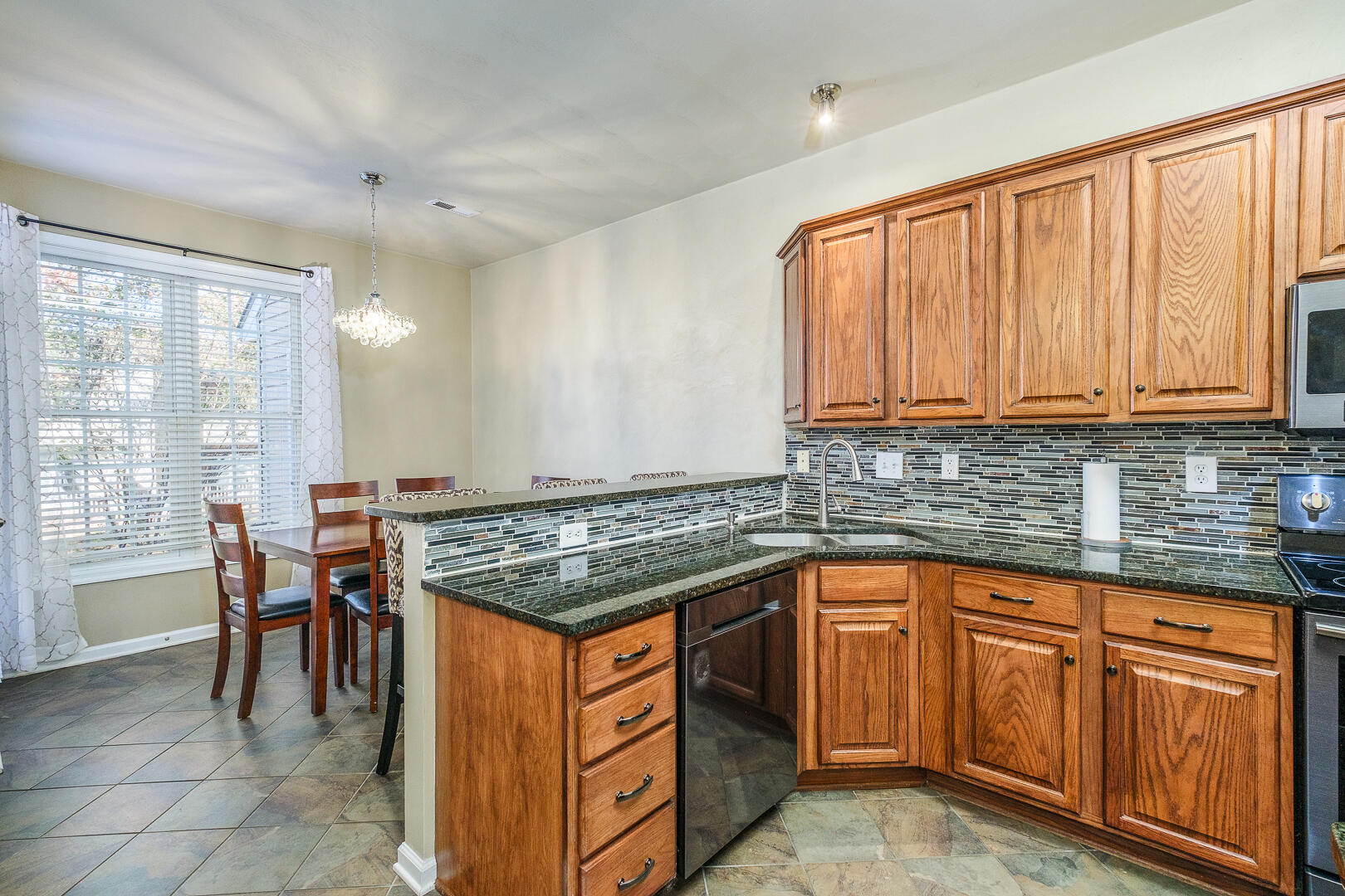 8717 Little Hoop Road Roanoke, VA 24019 - Photo 8 of 31 a kitchen with stainless steel appliances granite countertop a stove a sink and a microwave