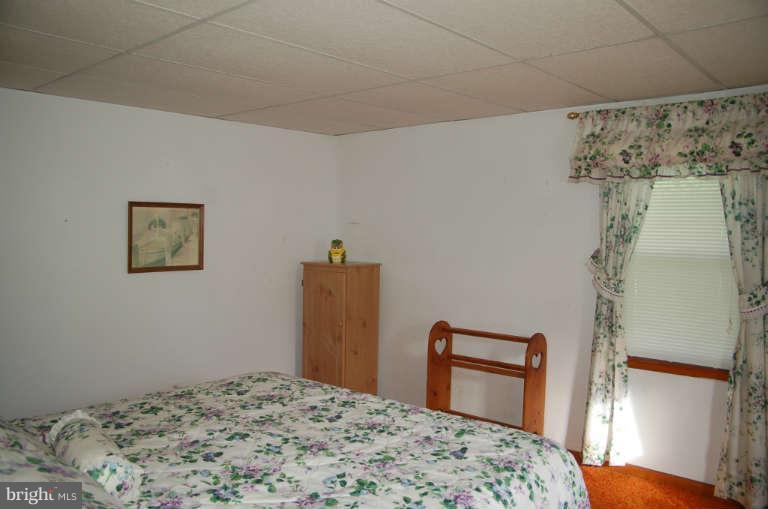 16541 Trenton Road Upperco, MD 21155 - Photo 11 of 18 a bedroom with a bed and a dresser
