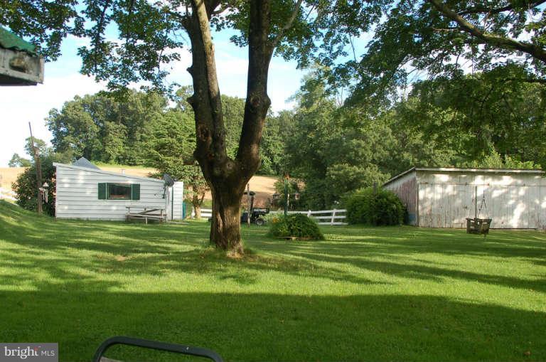 16541 Trenton Road Upperco, MD 21155 - Photo 18 of 18 a backyard of a house with lots of green space and fountain