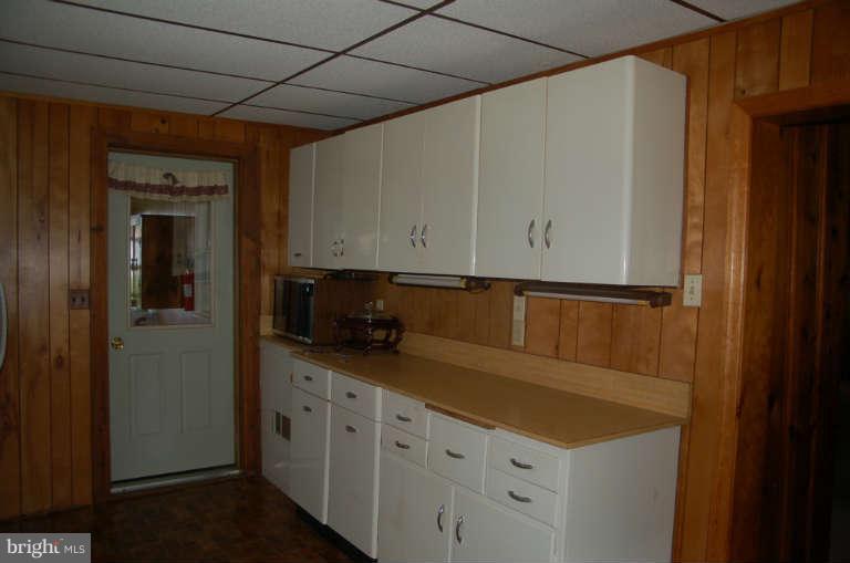 16541 Trenton Road Upperco, MD 21155 - Photo 4 of 18 a kitchen with granite countertop white cabinets and white appliances
