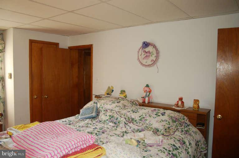 16541 Trenton Road Upperco, MD 21155 - Photo 9 of 18 a bedroom with a bed and a table in it