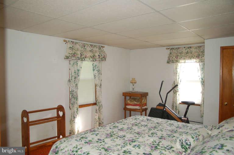 16541 Trenton Road Upperco, MD 21155 - Photo 10 of 18 a bedroom with a bed and a window