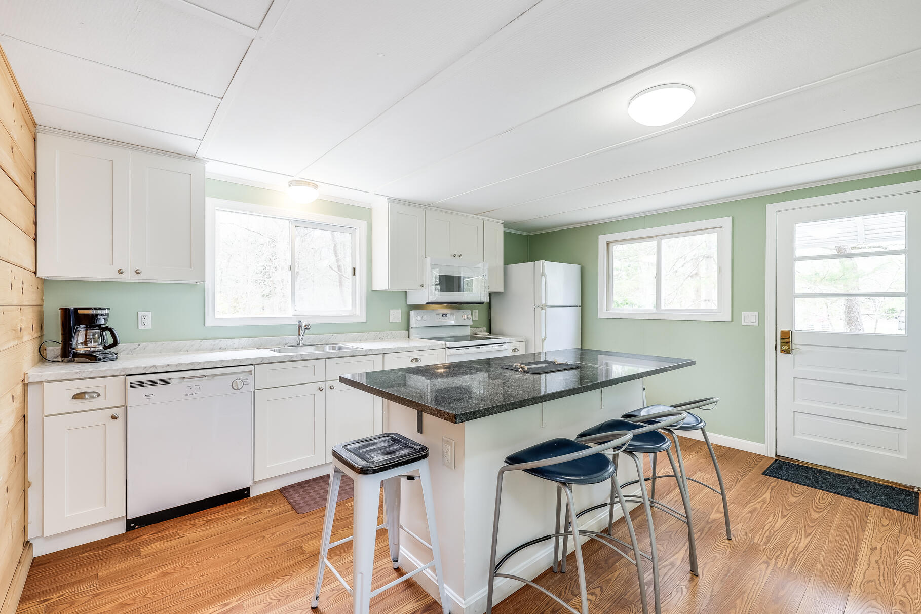 85 Boreen Road Eastham, MA 02642 - Photo 17 of 73 a kitchen with stainless steel appliances granite countertop table chairs sink and cabinets