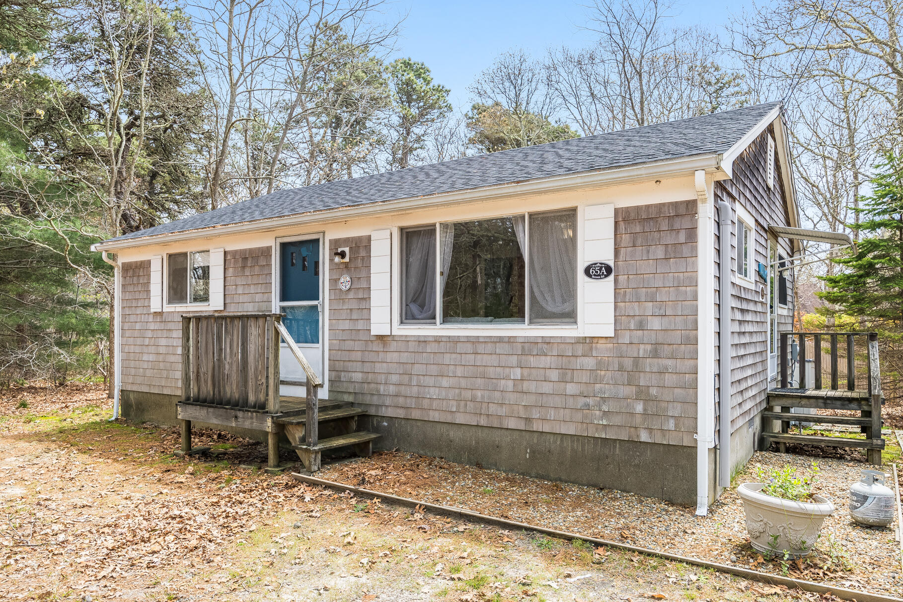 85 Boreen Road Eastham, MA 02642 - Photo 24 of 73 a view of a house with a yard and wooden fence