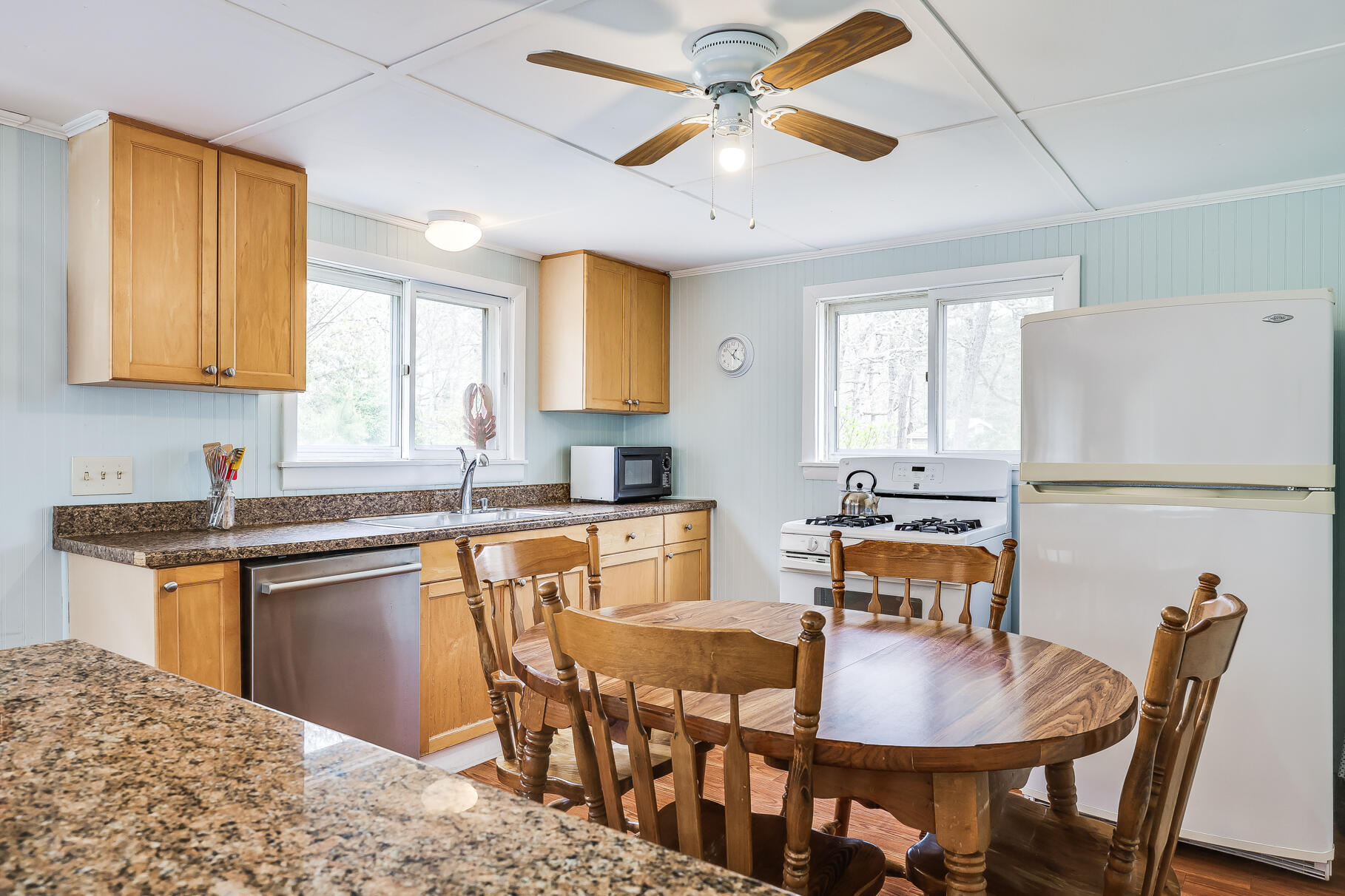 85 Boreen Road Eastham, MA 02642 - Photo 26 of 73 a kitchen with stainless steel appliances granite countertop a dining table chairs and a refrigerator