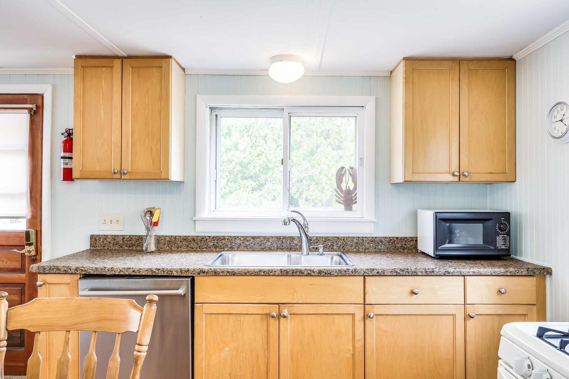 85 Boreen Road Eastham, MA 02642 - Photo 29 of 73 a kitchen with granite countertop a sink a window cabinets and stainless steel appliances