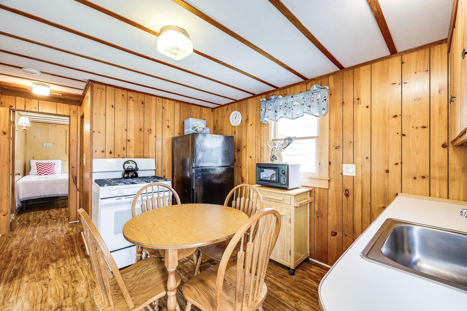85 Boreen Road Eastham, MA 02642 - Photo 48 of 73 a kitchen with sink refrigerator dining table and chairs