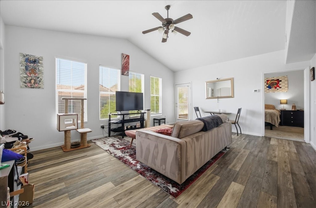 10550 West Alexander Road, Unit 2164 Las Vegas, NV 89129 - Photo 5 of 27 A relaxed living area offers high ceilings, rich wood flooring, and a private outdoor space.
