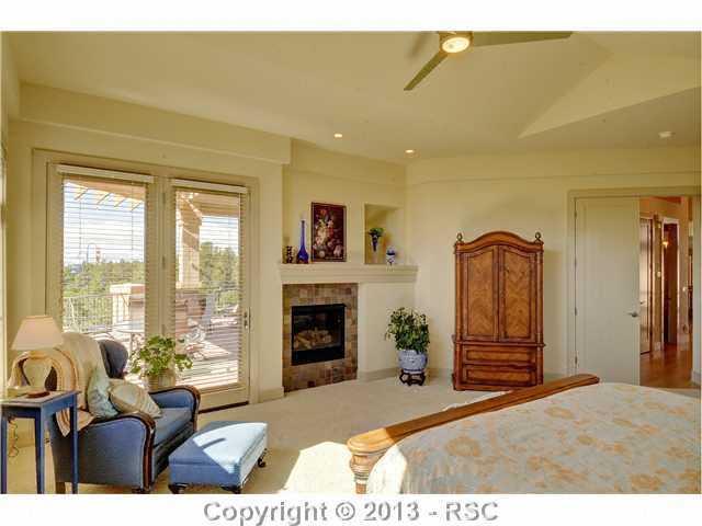 4265 Hidden Rock Road Colorado Springs, CO 80908 - Photo 15 of 25 Spacious Master Suite w/ Fireplace, Walk-out to Deck, 5-Piece Master Bath & Custom Walk-in Closet w/ Built-in Ironing Board
