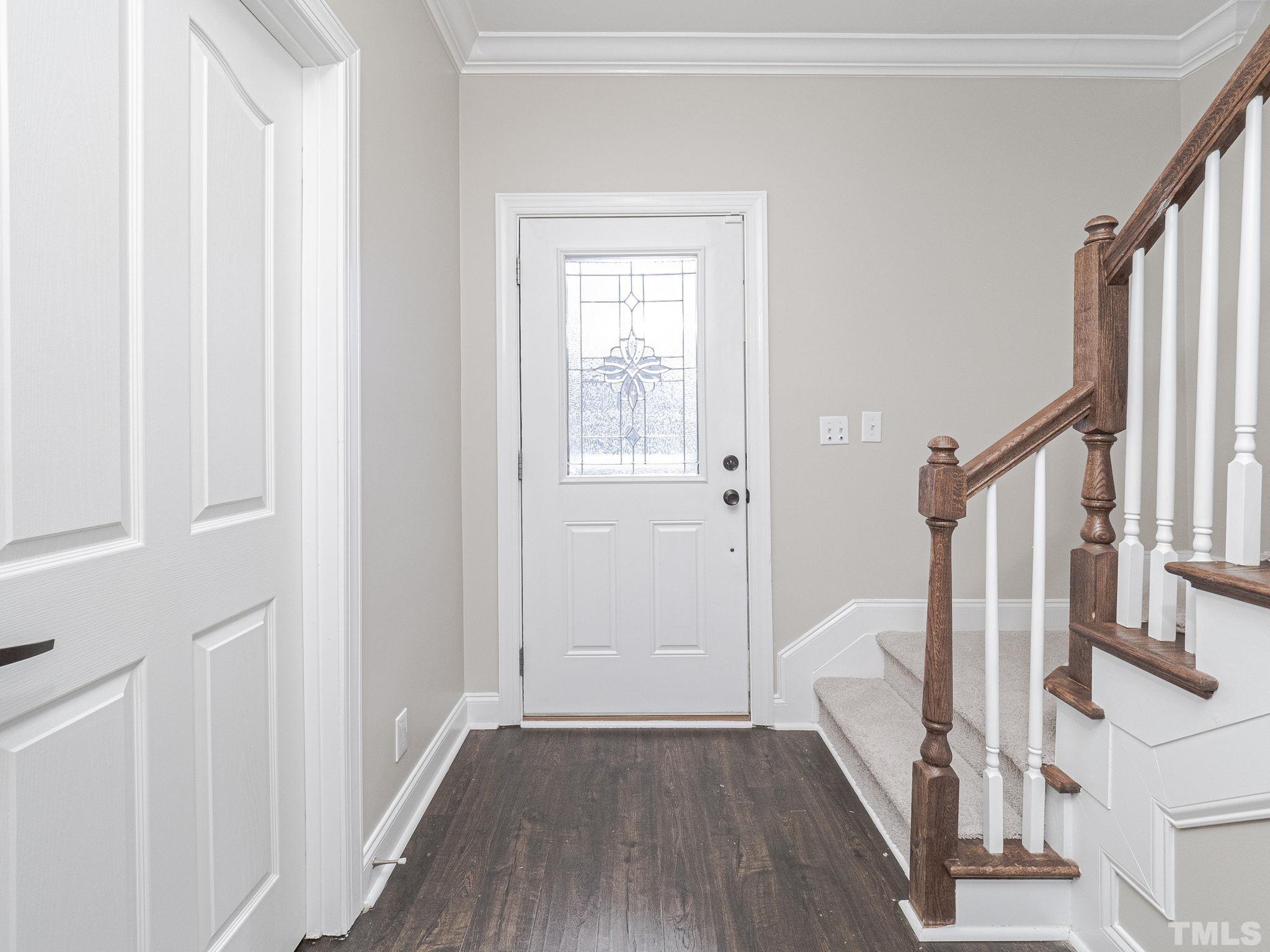 1213 Silver Farm Road Raleigh, NC 27603 - Photo 6 of 27 a view of a hallway with wooden floor and staircase