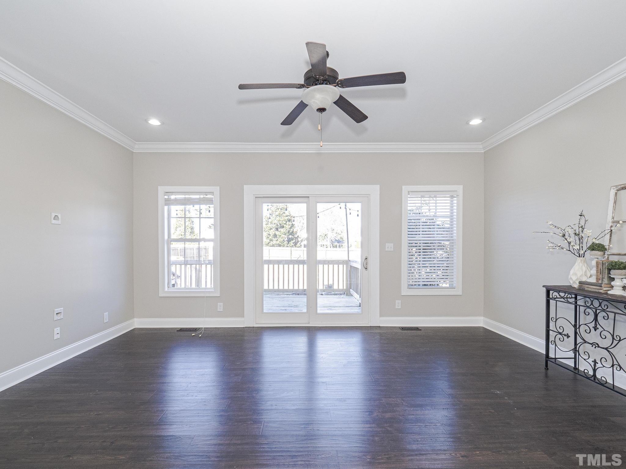 1213 Silver Farm Road Raleigh, NC 27603 - Photo 7 of 27 a view of an empty room with wooden floor and a window