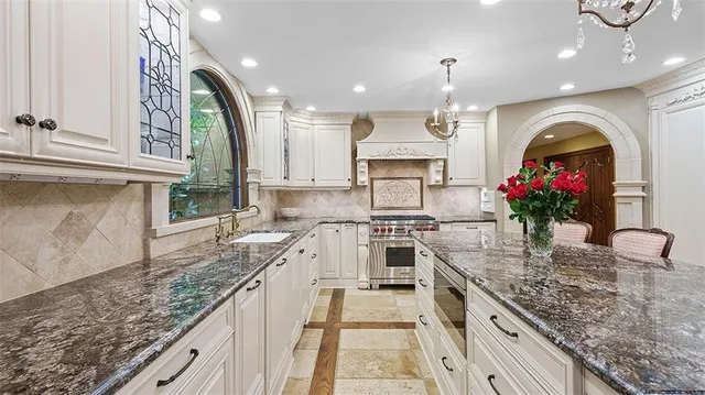 a living room with furniture and a open kitchen view