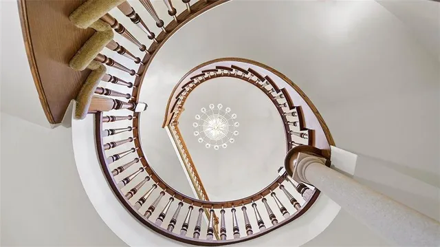 a kitchen with stainless steel appliances granite countertop a sink a stove and a wooden floors