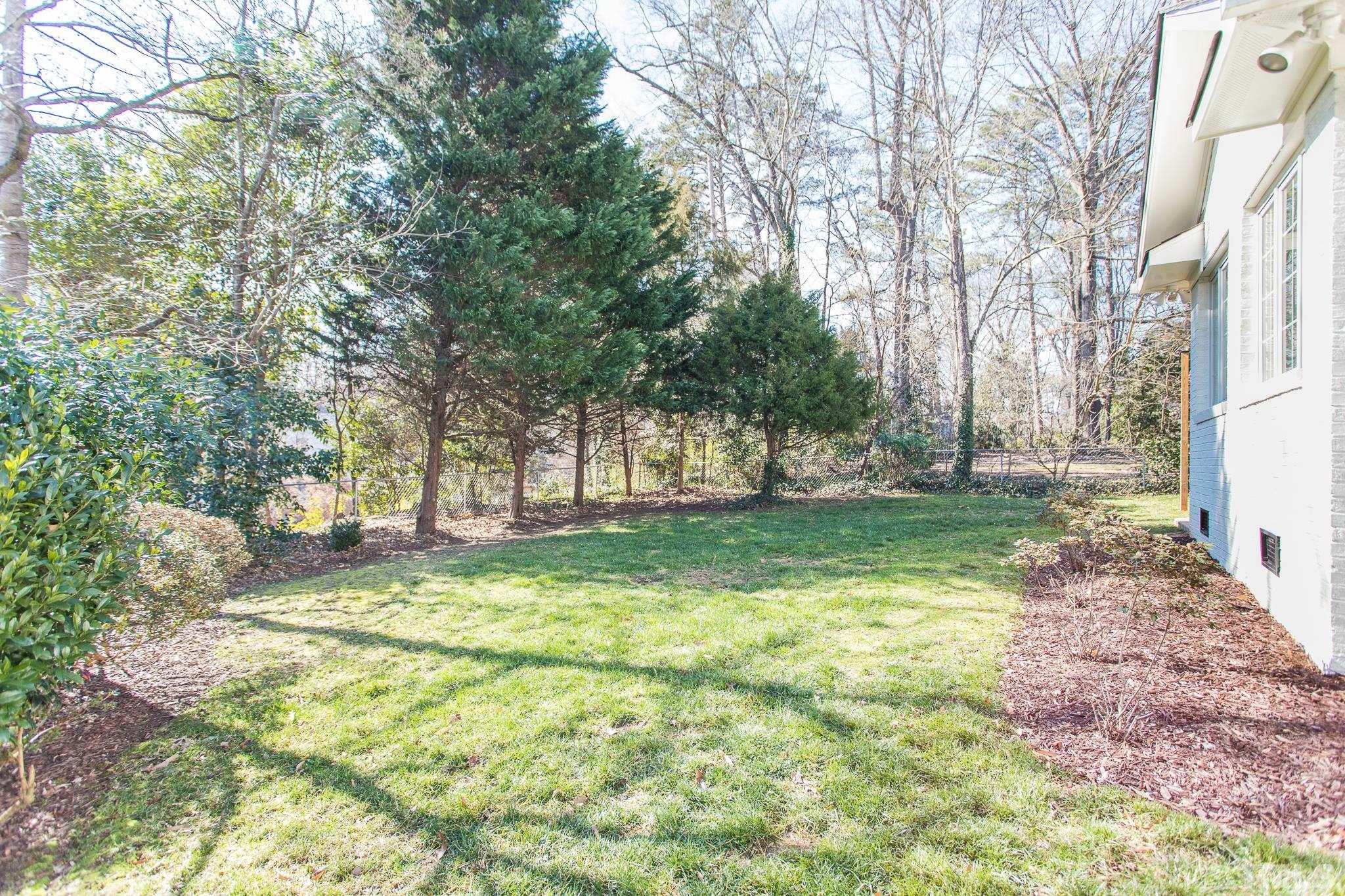 516 Harvard Street Raleigh, NC 27609 - Photo 30 of 31 a view of a yard with a tree