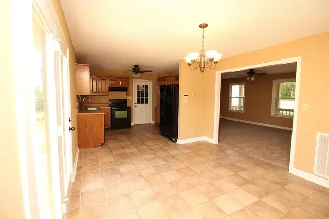 a view of a kitchen with a sink and refrigerator in it