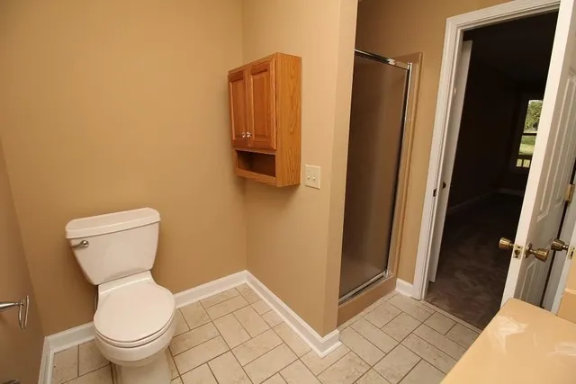 a white toilet sitting next to a sink