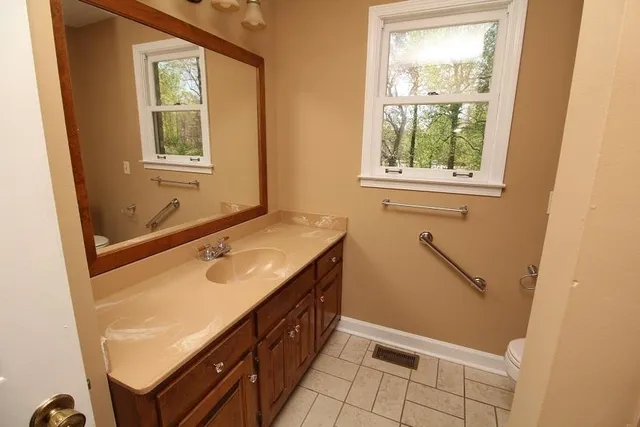 a bathroom with a sink and a window