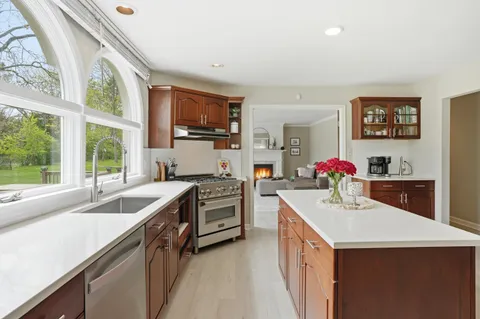 a kitchen with a sink stove top oven and microwave