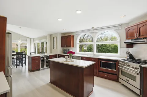 a kitchen with stainless steel appliances granite countertop a stove a sink and a refrigerator