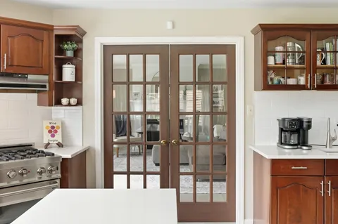 a kitchen with a stove a refrigerator and cabinets