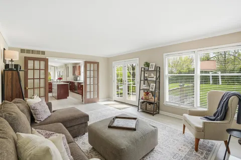 a living room with furniture and floor to ceiling windows