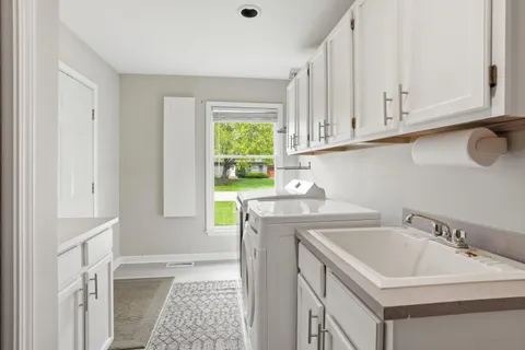 a utility room with a sink washer and dryer