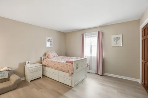 a bed room with a bed and a window
