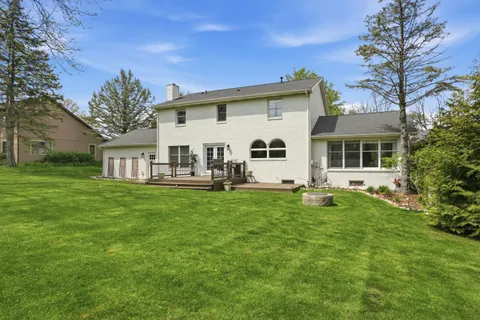 a view of a house with a backyard