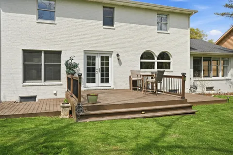 a view of a house with backyard sitting area and furniture